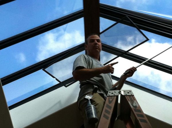 Man Applying Tinted Glass on Skylights